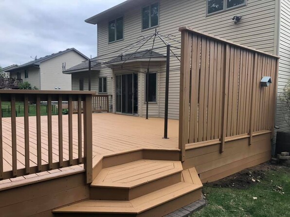 Railings of wood deck stained brown.